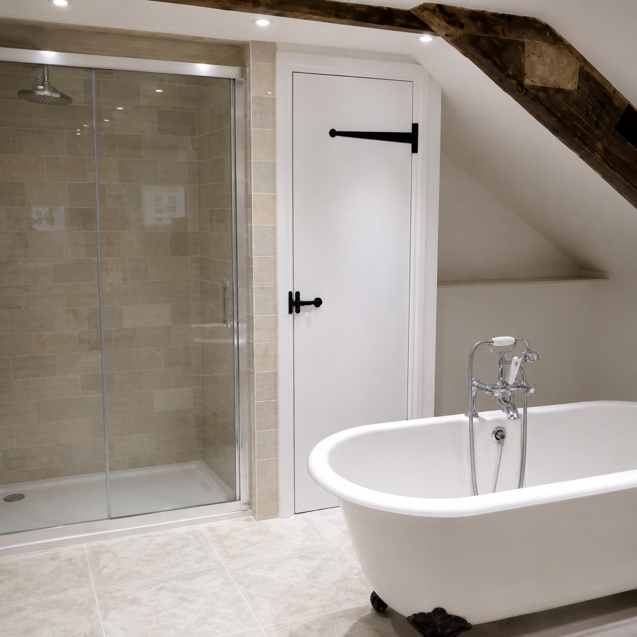 A modern bathroom with a glass shower, a freestanding white bathtub, beige tile floor, and an angled ceiling with exposed wooden beams.